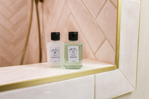 Two bottles of shampoo and conditioner on a bathroom counter. - Medical District Retreat 4 Bedroom Walk to Tech (Lubbock)