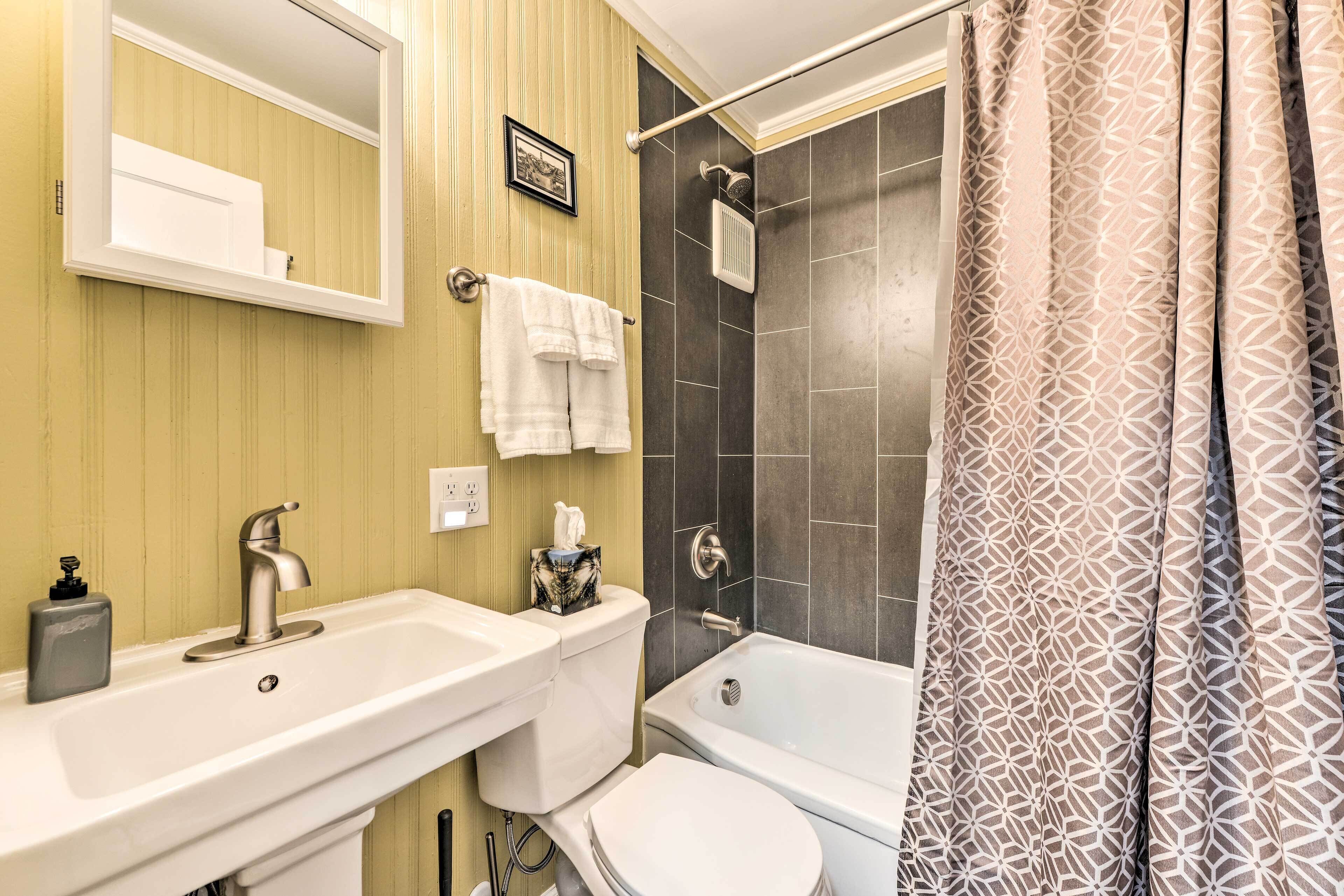 A bathroom with a white sink, a toilet, a bathtub, and a shower.