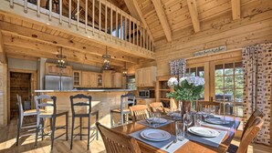 A spacious wooden cabin with a dining area, kitchen, and a balcony. - Lazy Beaver Lodge Pagosa Cabin w/ Deck, Fire Pit (Pagosa Springs)