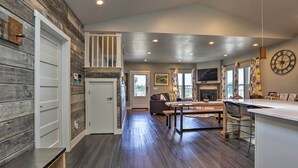 A spacious kitchen with a central island, a dining area with a sofa, and a large window providing natural light. - Sierra Sunset Inn - 3 Miles to Placerville! (Diamond Springs)