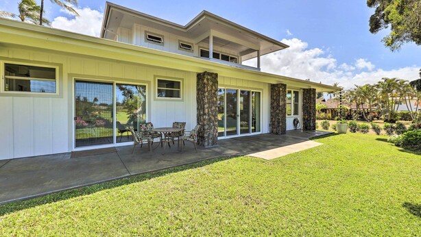 A modern two-story house with a covered patio, large sliding glass doors, and a well-maintained lawn. - Spacious Kauai Getaway < 1 Mi to the Ocean! (Princeville)