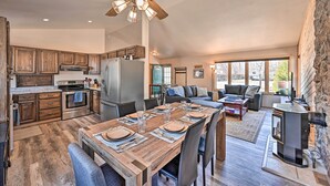 A spacious kitchen with wooden cabinets, a large dining table set for six, and a stone fireplace. - Charming Buena Vista Home w/ Hot Tub + Deck! (Buena Vista)