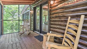 A wooden cabin interior with a rocking chair, a porch with a wooden floor, and a sign that reads "COUNTRY LIFE". - Mtn-view Cabin w/ Hot Tub in Sevierville! (Sevierville)