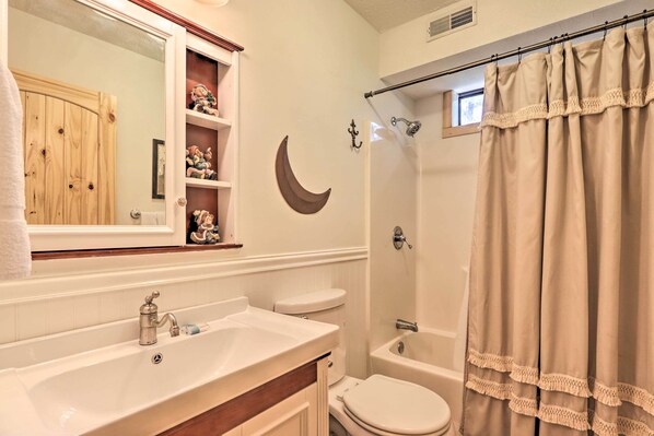 A bathroom with a sink, toilet, and shower. - Mtn-view Cabin w/ Hot Tub in Sevierville! (Sevierville)