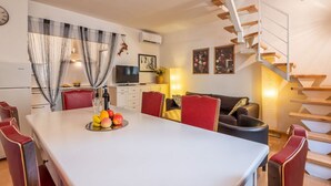 A modern interior with a dining area, a staircase, and a living room. - Modern Murate View in Florence by Mmega (Firenze)