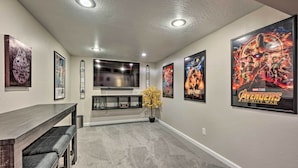 A home interior with a dining area, a TV, and framed posters on the walls. - Fenced Yard + Patio: Pet-friendly Denver Home Base (Arvada)