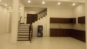 A spacious kitchen with wooden cabinets and a built-in stove. - Riverdale Ridge Apartment I (Kandy)
