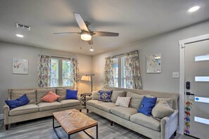 A living room with two sofas, a coffee table, a ceiling fan, and a door with a lock. - San Antonio Home ~ 4 Mi to Dtwn + The Pearl! (San Antonio)