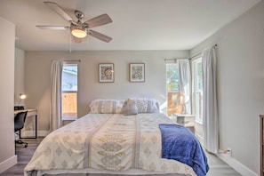 A bedroom with a bed, ceiling fan, two framed pictures, and a desk with a chair. - San Antonio Home ~ 4 Mi to Dtwn + The Pearl! (San Antonio)