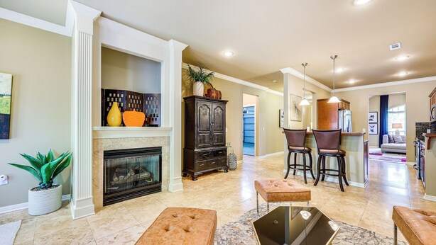 A spacious living room with a fireplace, a coffee table, and seating area.