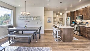 A modern kitchen with wooden cabinets, stainless steel appliances, and a central island. - Walk to Lifts: Condo w/ Mtn Views in Keystone! (Keystone)