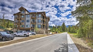 A multi-story building with a modern architectural design, featuring balconies and large windows. - Walk to Lifts: Condo w/ Mtn Views in Keystone! (Keystone)