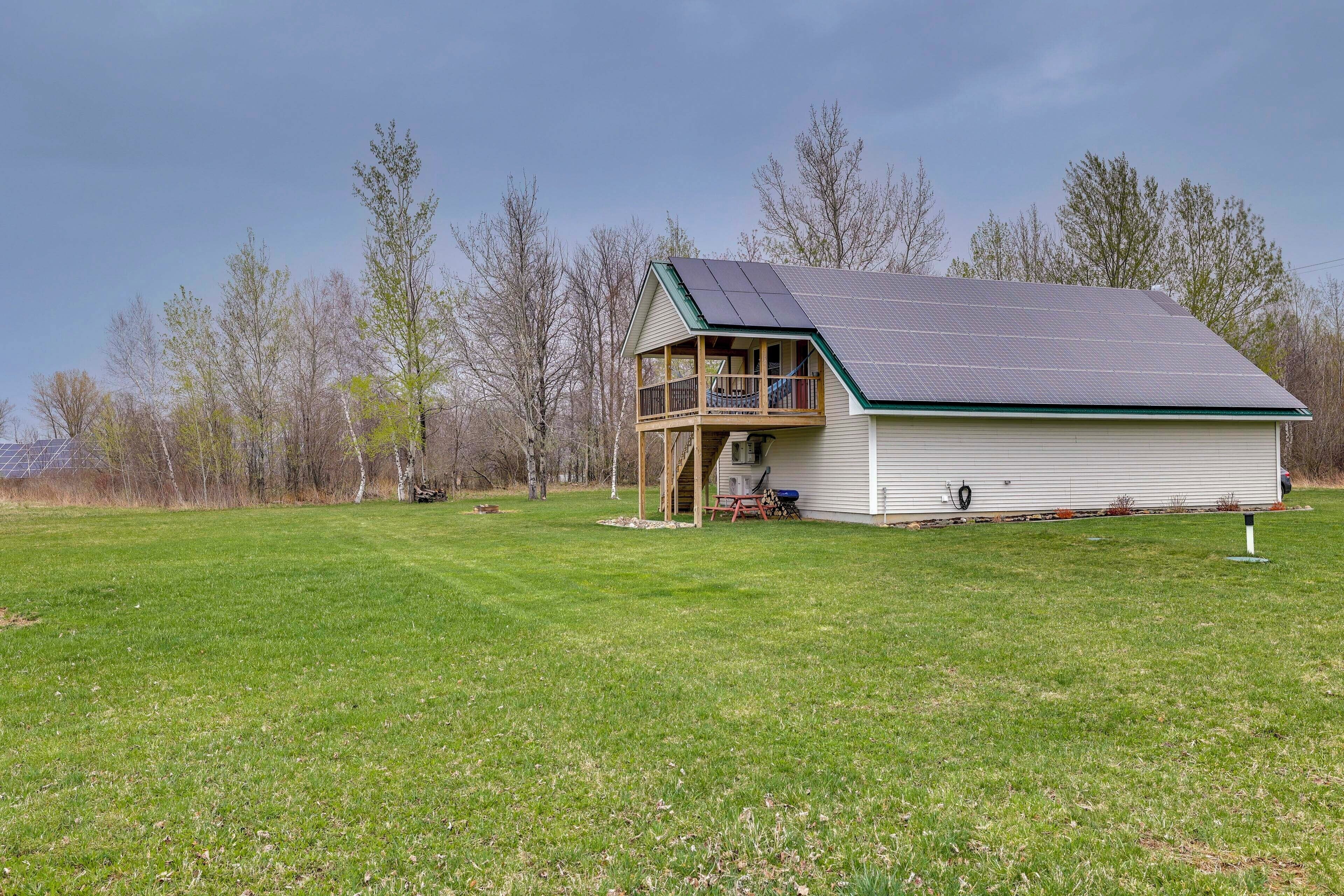 A single-story house with a green roof and a covered porch.