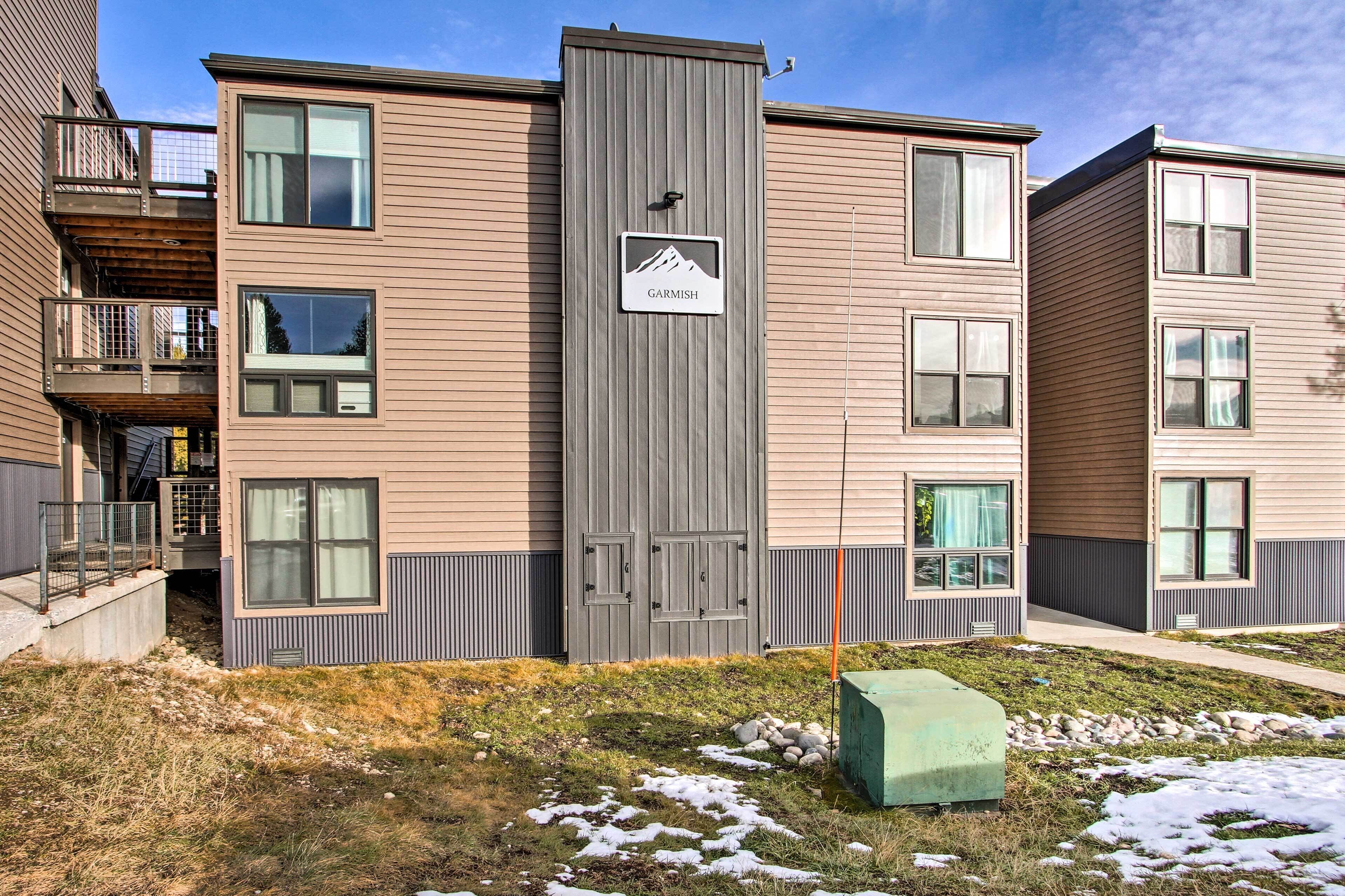 A modern multi-story building with a sign indicating 'Garmish'.