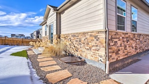 A house with a brick foundation and a stone pathway leading to the front door. - 10 Mi to Dia: Spacious Aurora House w/ Yard! (Aurora)