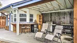 A covered outdoor kitchen area with a bar, grill, and seating. - Vancouver Home w/ Hot Tub < 15 Mi to Portland! (Vancouver)