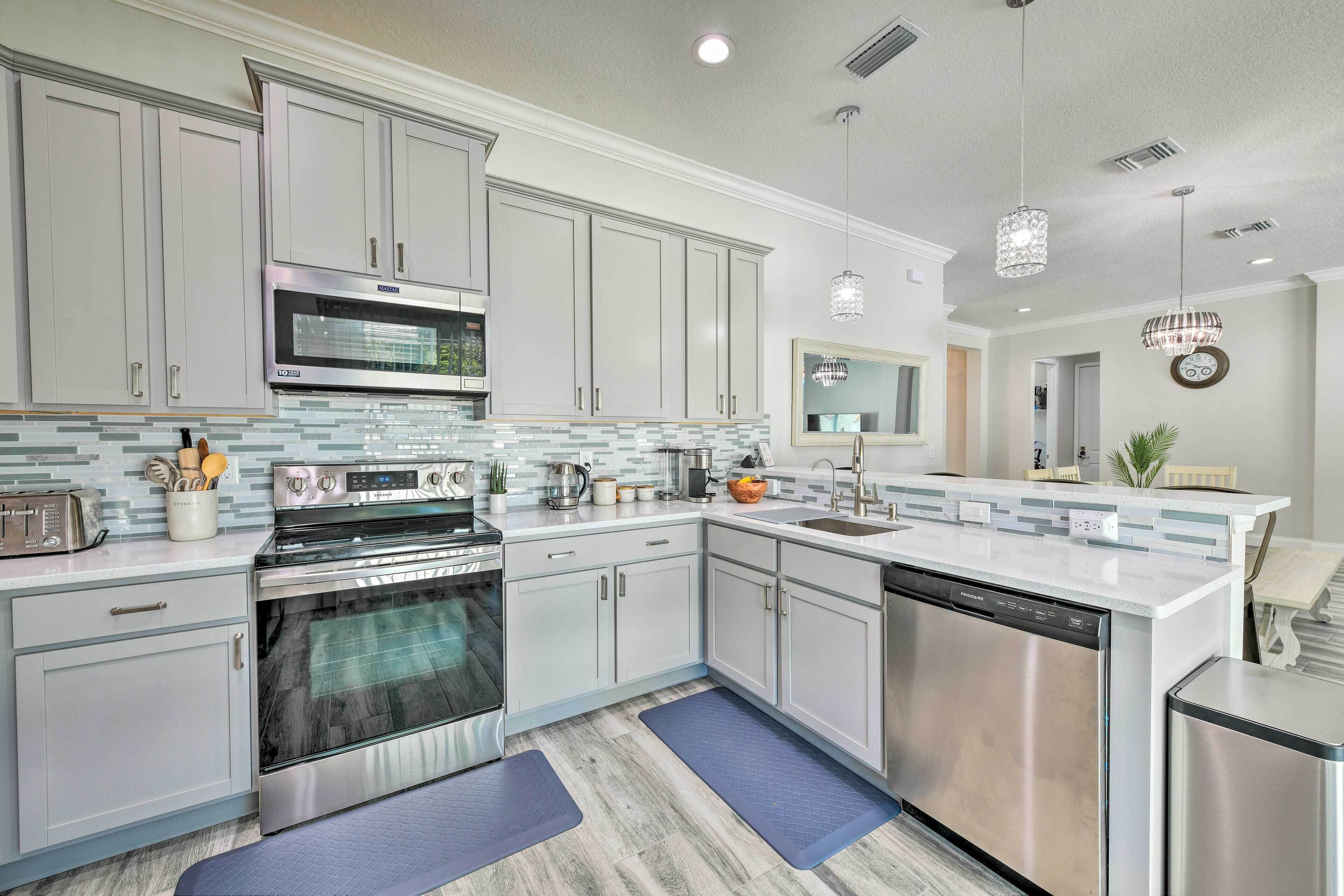 A modern kitchen with stainless steel appliances, a microwave, and a dishwasher.