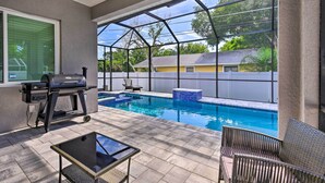 A covered patio with a pool, outdoor furniture, and a grill. - Beautiful Getaway ~ 4 Miles to Venice Beach! (Venice)