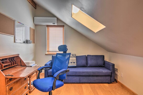 A room with a desk, chair, sofa, and a sloped ceiling with a skylight. - Dreamy Santa Fe Hideaway w/ Mountain Views! (Santa Fe)