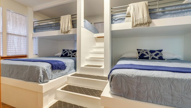 A room with bunk beds, a staircase, and a window with blinds. - Canyon Lake Home w/ Resort Amenities & Fire Pit! (Canyon Lake)