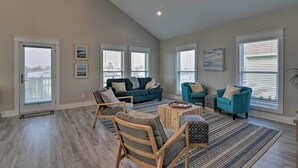 A spacious living room with a large sofa, two armchairs, a coffee table, and a patterned rug. - < 1 Mi to Sea Isle Beach: Home w/ Pool Access (Galveston)