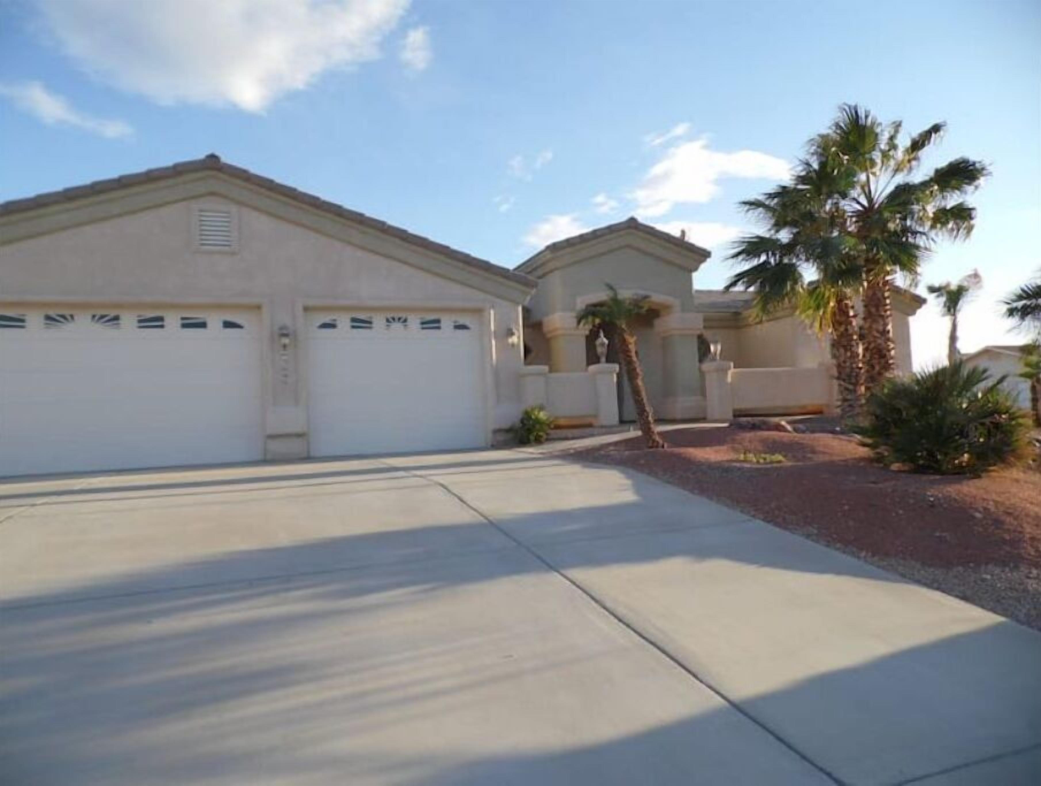 A two-story house with a garage and a driveway.