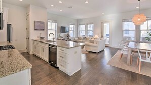 A spacious kitchen with white cabinetry, a granite countertop, and a built-in dishwasher. - Upscale Santa Rosa Beach Vacation Rental! (Santa Rosa Beach)