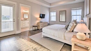 A bedroom with a bed, bedside table, lamp, dresser, TV, and a window. - Upscale Santa Rosa Beach Vacation Rental! (Santa Rosa Beach)