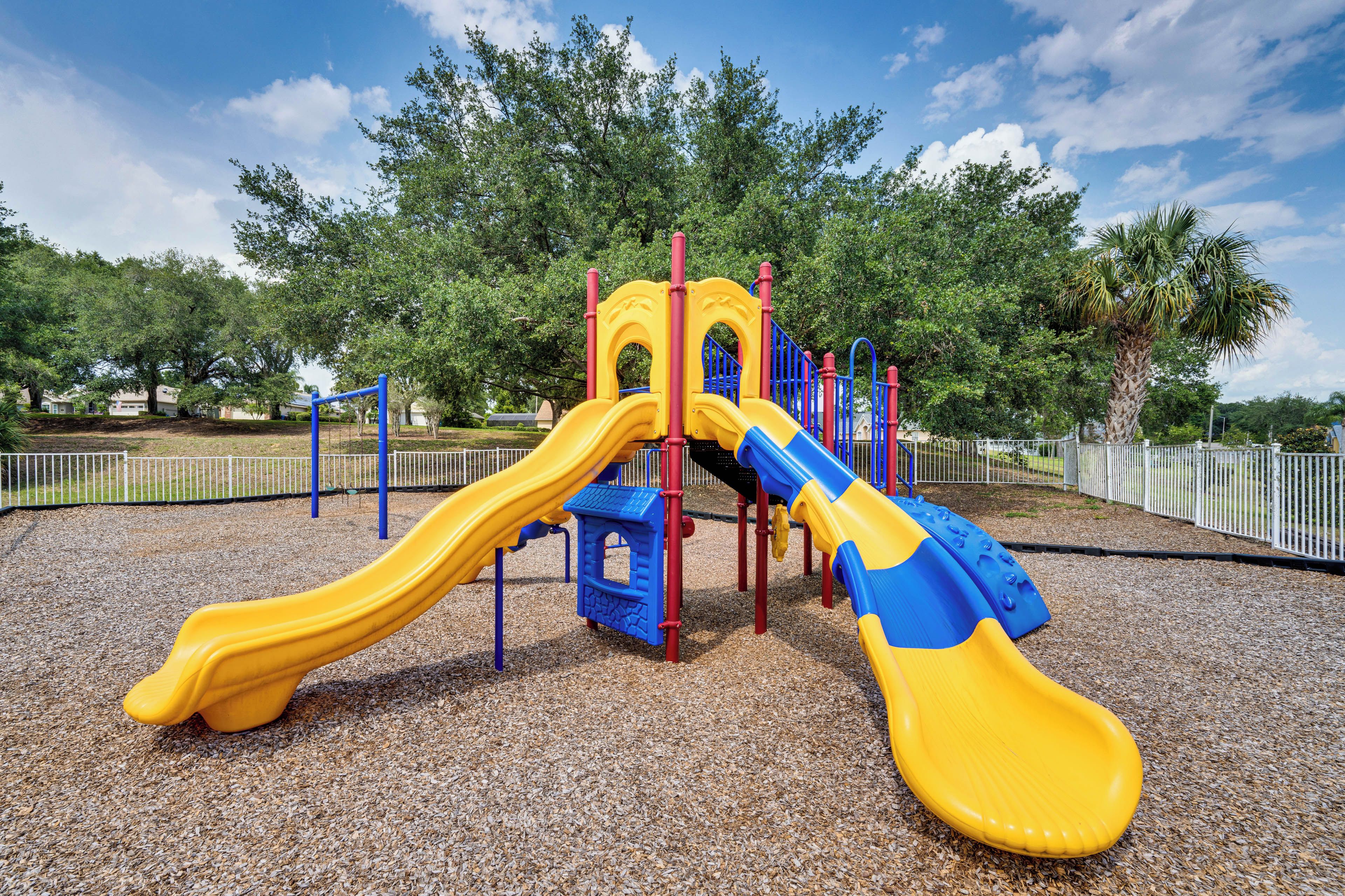 A playground with a slide and climbing structures.