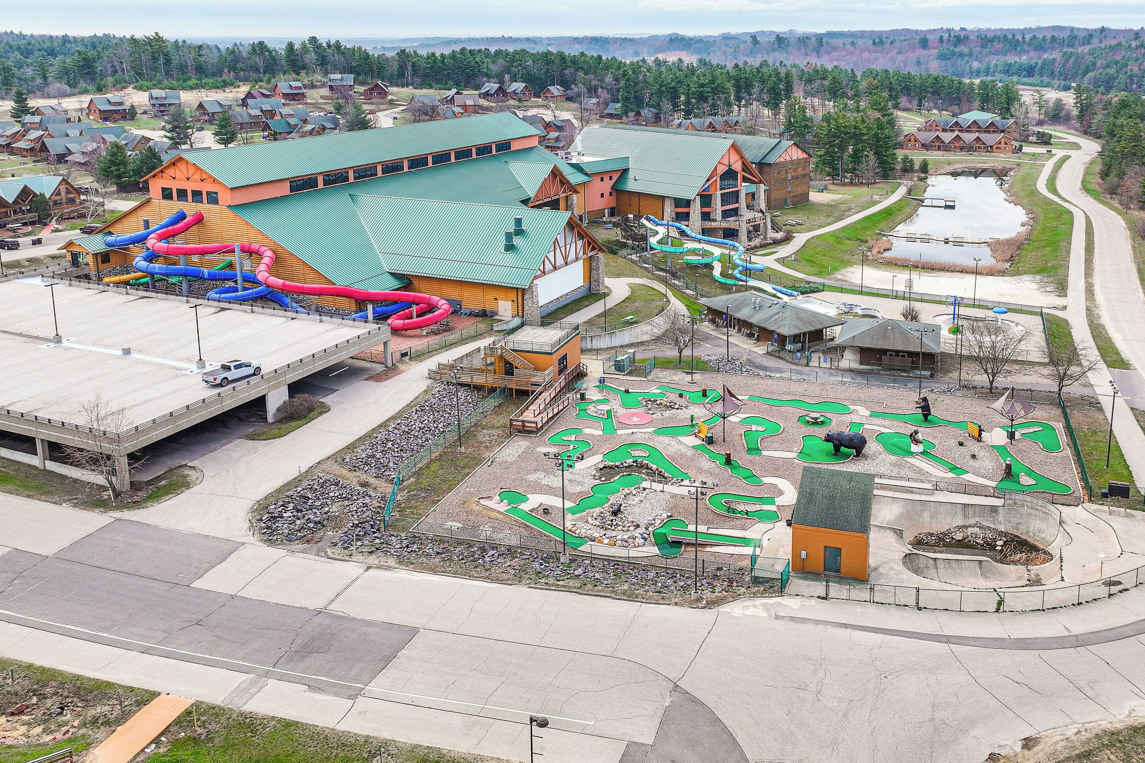 A large building with multiple slides and a playground area.