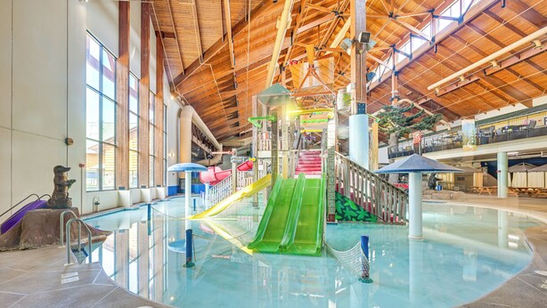 An indoor water park with multiple slides and a pool area. - Resort Cabin w/ Lake Access in Central Warrens! (Warrens)