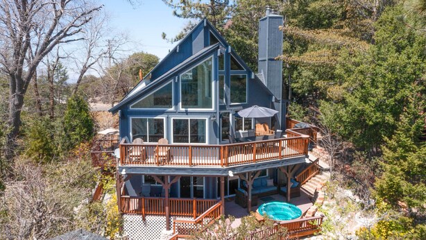 A two-story house with a balcony and a swimming pool.