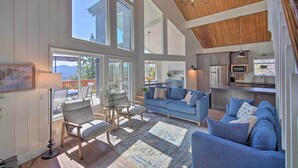 A spacious living area with a large sofa, a dining table, and a kitchen area with modern appliances.