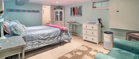 A bedroom with a bed, dresser, desk, and chair.