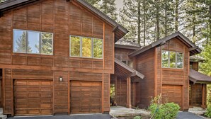 A wooden cabin with two garage doors, a stone pathway, and a small garden area. - Forest-view Gem 2 Mi to Diamond Peak Ski Resort! (Incline Village)