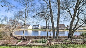 Uitzicht op een meer met huizen, bomen en een steiger.