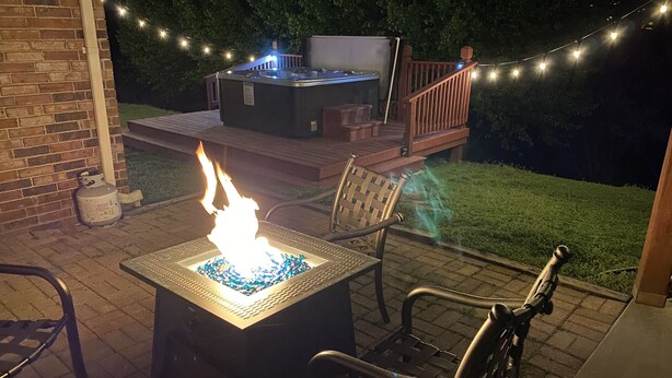 An outdoor patio with a fire feature, seating, and a hot tub. - Deer Valley 164 (Branson)