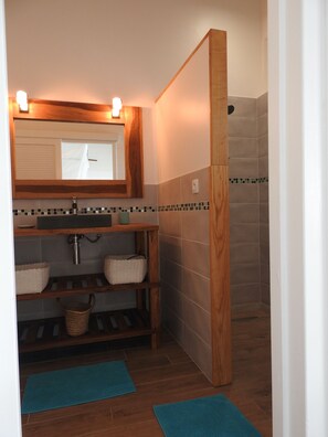 A bathroom with a wooden vanity, a mirror, a sink, and a shower area. - Villa Coco Câline, 2 suites, infinity pool (Capesterre-de-Marie-Galante)