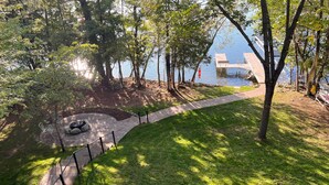 A park area with a paved path, benches, and a small water feature. - Crandon Cabin Getaway w/ Boat Dock & Deck! (Crandon)
