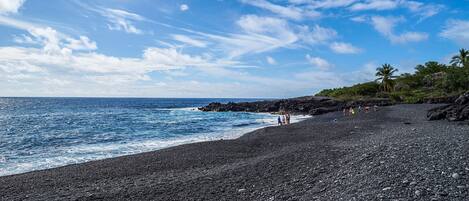 A rocky beach with a clear sky and ocean.
