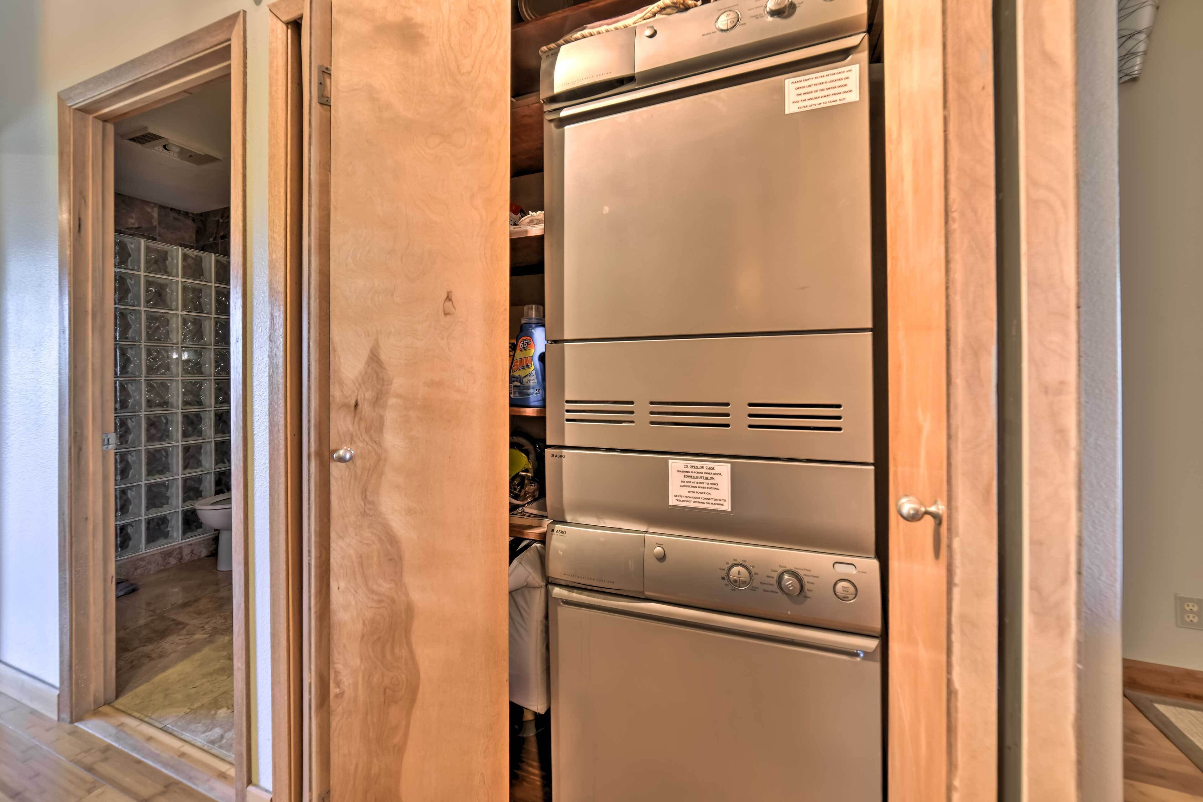 A compact kitchen with a built-in oven and a refrigerator.