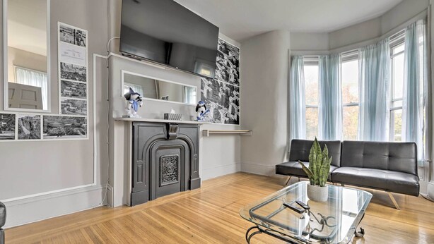 A living room with a fireplace, a sofa, and a coffee table. - Charming Springfield Apt < 2 Mi to Downtown! (Springfield)