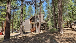 A two-story cabin surrounded by tall pine trees in a forested area. - 1 Mi to Skiing & Beaches: Incline Village Home! (Incline Village)