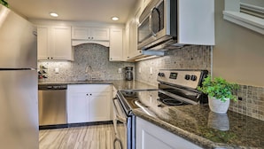 A modern kitchen with white cabinets, a stainless steel refrigerator, a built-in microwave, a stove, and a dishwasher. - 1 Mi to Skiing & Beaches: Incline Village Home! (Incline Village)