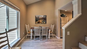 A dining area with a table and chairs, a painting on the wall, and a staircase leading to another room. - 1 Mi to Skiing & Beaches: Incline Village Home! (Incline Village)