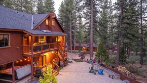 A two-story wooden cabin with a balcony, outdoor seating area, and a fireplace. - 2 Blocks to Lake Tahoe! Group Gem w/ Hot Tub (Incline Village)