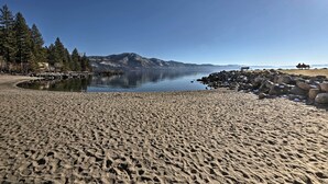 A sandy beach with a calm lake, rocky shoreline, and a mountain in the background. - 2 Blocks to Lake Tahoe! Group Gem w/ Hot Tub (Incline Village)