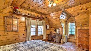 A cozy wooden cabin bedroom with a bed, dresser, vanity, and a window. - Big Bear Lake Cabin ~ 4 Mi Snow Summit Ski Resort (Big Bear Lake)