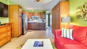 A compact kitchen with wooden cabinets, a refrigerator, and a microwave. - Oceanfront Kailua-kona Islander Studio w/ Lanai! (Kailua-Kona)