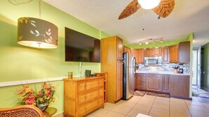A kitchen with wooden cabinets, a refrigerator, and a microwave. - Oceanfront Kailua-kona Islander Studio w/ Lanai! (Kailua-Kona)